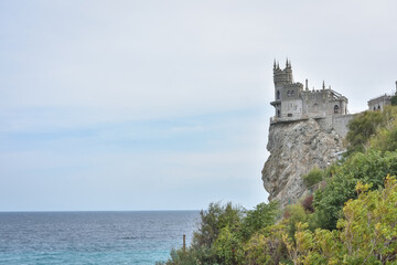 Yalta, Crimea, Russia - September 16, 2020: The decorative Neo-Gothic castle "Swallow's Nest" on the rock over the Black Sea
