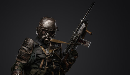 Studio shot of military man in spirit of post apocalypse with shotgun staring at camera.