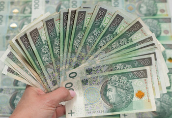 Polish money in hand, fan of hunderd polish zloty notes cash, plenty off 100 polish notes,...
