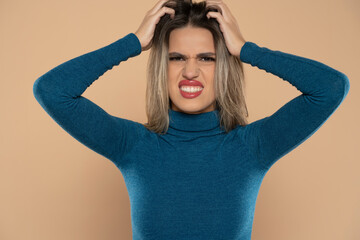 Young woman scratching head on beige background. Annoying itch - obrazy, fototapety, plakaty