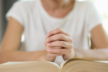 Female hands on book close up, shallow depth of field.