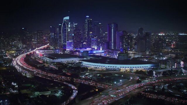 

Magnificent Aerial View of Los Angeles at Night. Skyscrapers in the Financial District and 110 and 10 Freeway Full of Cars. United Sates. California.  Blurred Brands and Logos. Shot in 8K. 