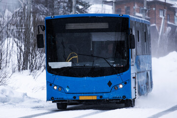 Bus on winter road through coniferous forest