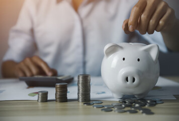 man putting coins in piggy bank Savings and investment ideas to maximize profits.