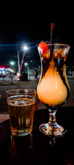 Tropical fruit drink with strawberry, vodka, condensed milk and chocolate sauce