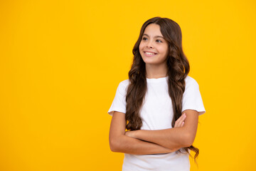 Confident child keep arms crossed, isolated on yellow background, empty space. Little caucasian...