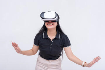 A young woman explores a VR environment via a virtual reality headset. Isolated on a white backdrop.