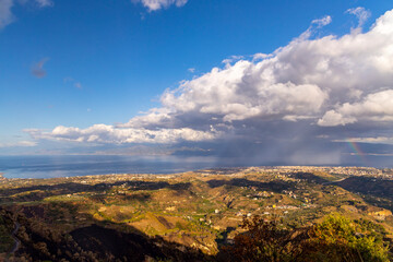 landscape illuminated by morning sun near Reggio di Calabria with island of Sicily, Italy
