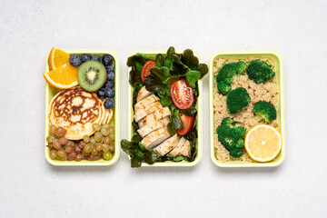 Ready meals for Breakfast, lunch, dinner in green recyclable containers on  white background. Delivery menu, lunch box concept