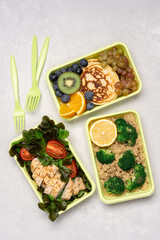Ready meals for Breakfast, lunch, dinner in green recyclable containers on  white background. Delivery menu, lunch box concept