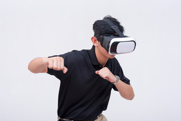 A young man playing a VR boxing game via a virtual reality headset. Isolated on a white backdrop.
