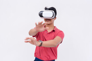 A young asian man explores a VR environment via a virtual reality headset. Isolated on a white backdrop.
