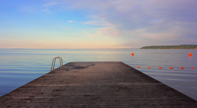 Bridge By A Peaceful Danish Beach And Calm Sea At Sunset In Summer