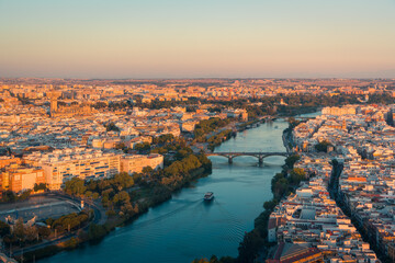 City of Seville with river and bridges under cloudless sky