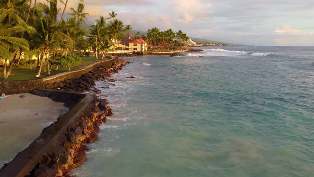 Drone view of buildings on the shore surrounded by the sea in Kailua-Kona, Hawaii