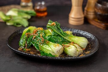 Deliciously cooked bok choy on a plate on the table - great for menus and catering services