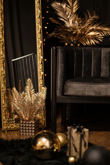 Merry Christmas and Happy Holidays!Beautiful black modern living room decorated for Christmas.Chrystmas Luxury black style living room interior with sofa decorated chic , golden style.Selective focus.