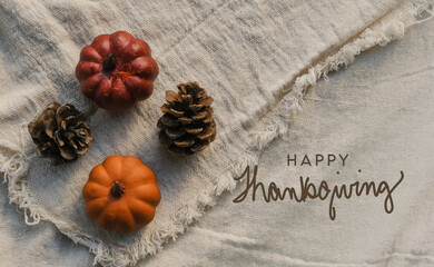 happy thanksgiving on canvas texture background with earthy and natural organic style copy for holiday.