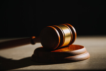 Justice and law concept.Male judge in a courtroom with the gavel, working with, computer and...