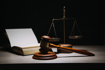 Justice and law concept.Male judge in a courtroom with the gavel, working with, computer and...