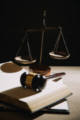 Justice and law concept.Male judge in a courtroom with the gavel, working with, computer and docking keyboard, eyeglasses, on table in morning light