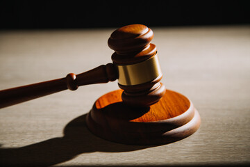 Justice and law concept.Male judge in a courtroom with the gavel, working with, computer and...