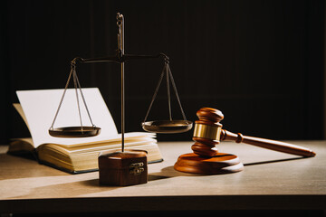 Justice and law concept.Male judge in a courtroom with the gavel, working with, computer and...