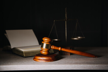 Justice and law concept.Male judge in a courtroom with the gavel, working with, computer and...