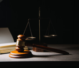 Justice and law concept.Male judge in a courtroom with the gavel, working with, computer and...