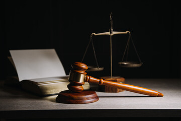 Justice and law concept.Male judge in a courtroom with the gavel, working with, computer and...