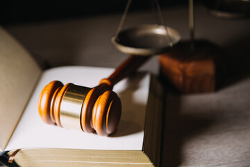 Justice and law concept.Male judge in a courtroom with the gavel, working with, computer and docking keyboard, eyeglasses, on table in morning light