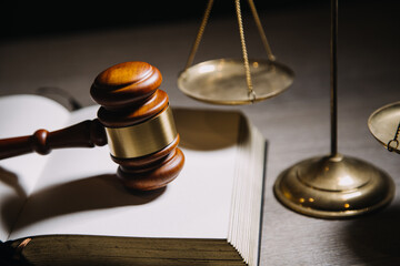 Justice and law concept.Male judge in a courtroom with the gavel, working with, computer and...