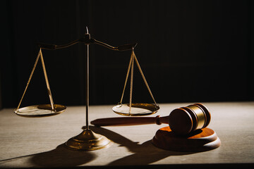 Justice and law concept.Male judge in a courtroom with the gavel, working with, computer and...