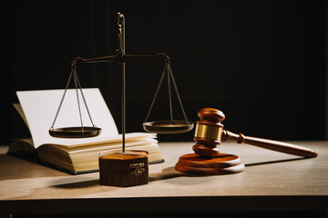 Justice and law concept.Male judge in a courtroom with the gavel, working with, computer and docking keyboard, eyeglasses, on table in morning light