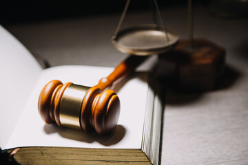 Justice and law concept.Male judge in a courtroom with the gavel, working with, computer and...