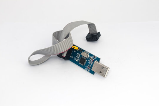 An AVR microcontroller downloader with USB port and connecting cable.