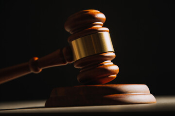 Justice and law concept.Male judge in a courtroom with the gavel, working with, computer and...