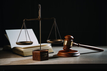 Justice and law concept.Male judge in a courtroom with the gavel, working with, computer and docking keyboard, eyeglasses, on table in morning light