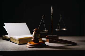 Justice and law concept.Male judge in a courtroom with the gavel, working with, computer and...