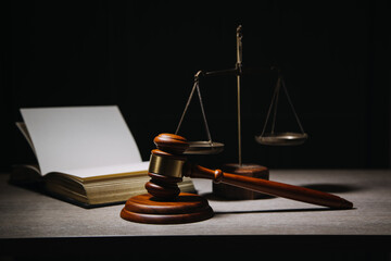 Justice and law concept.Male judge in a courtroom with the gavel, working with, computer and docking keyboard, eyeglasses, on table in morning light