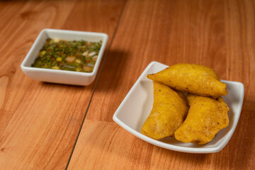 Colombian empanada with spicy sauce