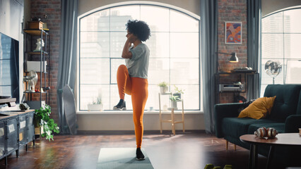 Concentrated Positive Black Woman Doing Cardio, High Knees and Squat Exercises During Daily Workout at Cozy Home. Strong and Fit Girl Committing to Healthy Lifestyle. Fitness and Recreation Concept.