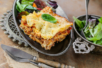 lasagnes fait maison avec salade sur table en métal 