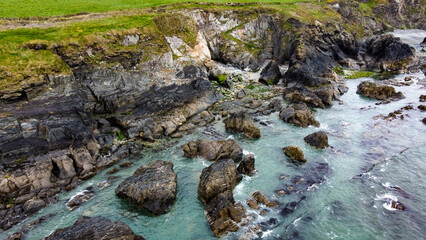 Tidal waves of the Atlantic Ocean near the southern coast of the island of Ireland. Rocky seashore. Seascape, top view. Drone point of view. View from above.