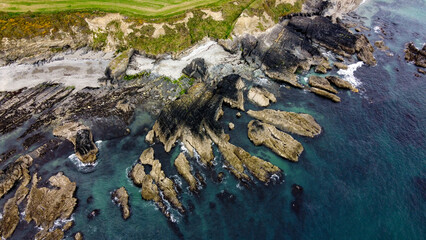 Rocks on the Irish coast, top view. The coast of the Atlantic Ocean. Nature of Northern Europe. Rocky coastline. Aerial photo.