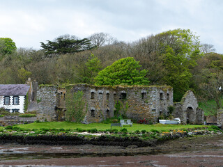 Fototapeta na wymiar The Arundel grain store, shore of Clonakilty Bay in the spring. An old stone building in Ireland, Europe. Historical architectural monument, landscape. Tourist attractions in Ireland