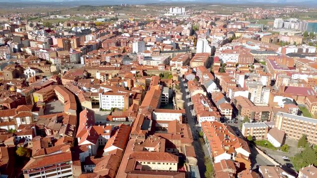 Aerial point ow view of Leon city. Situated in northwest of Spain is an old historic city and an important travel destination. Drone backward passing above the Cathedral of Leon and tilt up