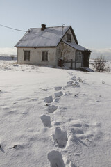 Footprints in the snow on the background of the house