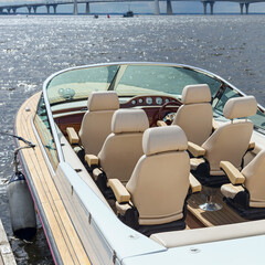 view of the luxurious interior of a modern motor boat, standing near the pier of the sea harbor in...