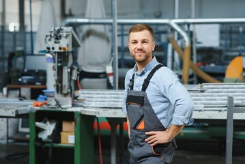 Manual worker works in a carpentry factory, he is assembling PVC windows and doors. Aluminum and PVC windows and doors production.